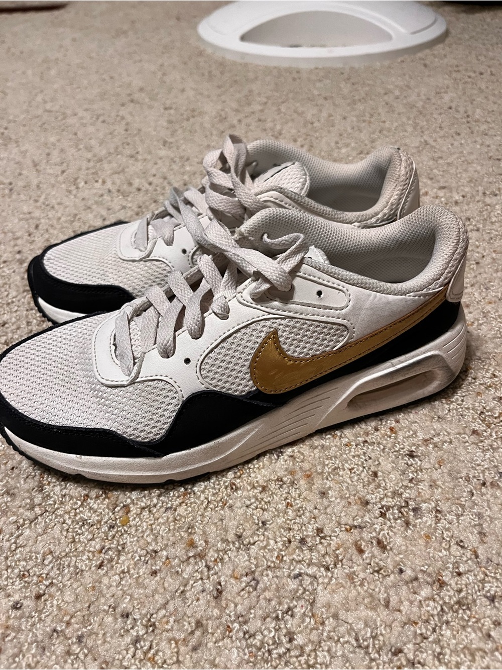 Nike White and Black Mesh Sneakers with Gold Swoosh